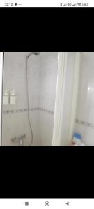 a bathroom with a shower with a shower head at Hogar calido calafell in Calafell +1 photo