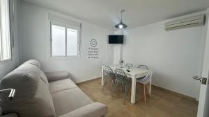 a living room with a couch and a table at Mirador Playa in Conil de la Frontera