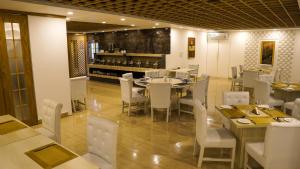 a restaurant with a table and chairs and a bar at Grand Vistana in Dhaka