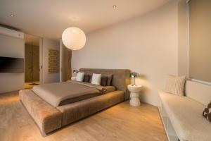 a bedroom with a bed and a couch at Luxury 4BD Villa with Oceanview in Uluwatu in Uluwatu +51 photos