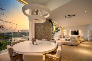 a dining room with a white table and chairs at Luxury 4BD Villa with Oceanview in Uluwatu in Uluwatu