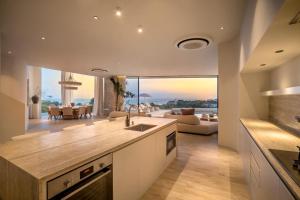 a kitchen with a view of a living room at Luxury 4BD Villa with Oceanview in Uluwatu in Uluwatu
