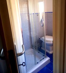 a bathroom with a shower and a toilet at 99 Scalini in Naples
