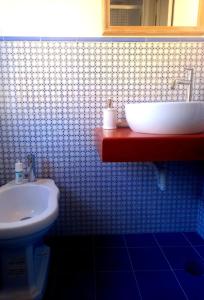 a bathroom with a white sink and a toilet at 99 Scalini in Naples