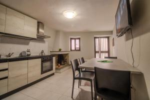 een keuken met een tafel en stoelen in een kamer bij Il Tuo Palazzetto in Castelsardo
