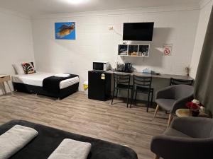 a small room with a bed and a table and chairs at Spanish Lace Motor Inn in Townsville