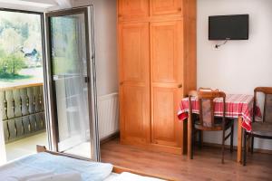 a room with a table and a table and a mirror at Penzion Rožič in Bohinj