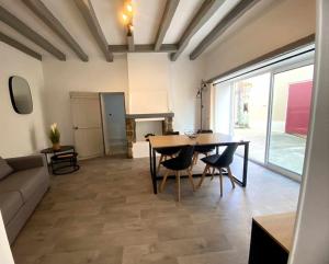 a living room with a table and chairs and a couch at Maison Saint Florent Le Vieil in Saint-Florent-le-Vieil