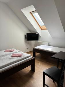 a bedroom with two beds and a skylight at WILLA ELITA in Krynica Morska