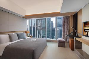 a bedroom with a bed and a large window at Ascott IFC Guangzhou - Free Shuttle Bus For Canton Fair in Guangzhou