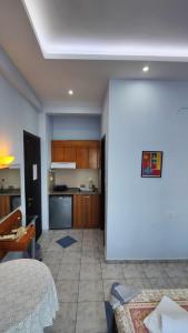 a room with a kitchen and a living room at Paschalitsa Rooms in Prinos +18 photos