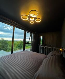a bedroom with a bed and a large window at Eco House 1 in Prestatyn