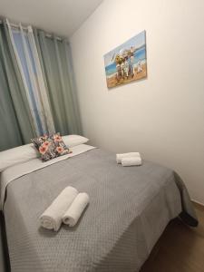 a bedroom with two towels on a bed at Maria Apartment in Vaccarizzo - Delfino +18 photos