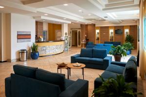 a lobby with blue couches and a table at Baglio Dello Zingaro in Scopello