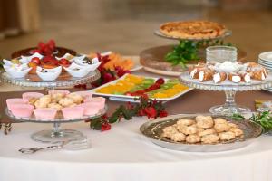 a table topped with different types of food on plates at Baglio Dello Zingaro in Scopello