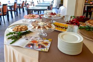 a table with plates of food on top of it at Baglio Dello Zingaro in Scopello