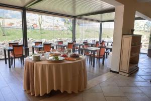 a dining room with a table with food on it at Baglio Dello Zingaro in Scopello