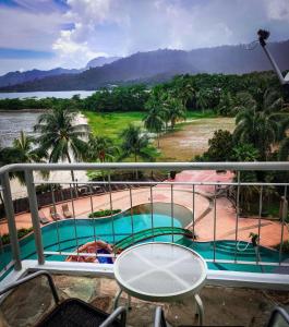 uma varanda com vista para uma piscina em Langkawi Lagoon Resort Seaview em Pantai Cenang