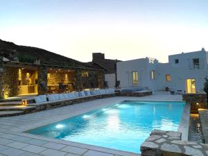a swimming pool in front of a house at Villa Artemis in Agios Georgios