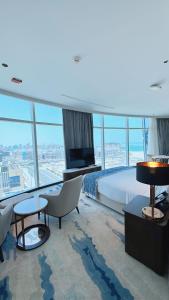 a hotel room with a bed and a television at Century Marina Hotel - Lusail in Lusail