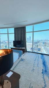 a hotel room with a bed and a large window at Century Marina Hotel - Lusail in Lusail