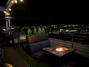 a couch and a fire pit on a rooftop at night at Hotel Nell - Union Market in Washington