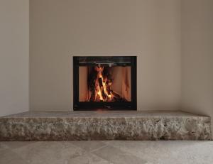 a fireplace with a stone bench in front of it at Borgo SAN SONNEA Lake Garda in Torri del Benaco