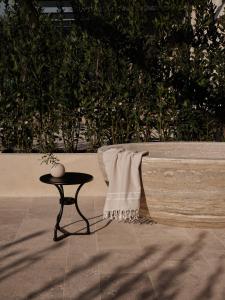 a table with a towel on it next to a bench at Borgo SAN SONNEA Lake Garda in Torri del Benaco