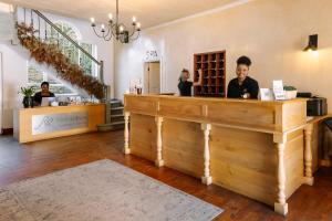 a woman standing at a counter in a salon at Auberge Burgundy Boutique Hotel & Spa in Hermanus +37 photos