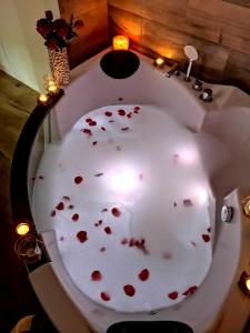a bath tub filled with red hearts on a table at JACUZZI SPA Green Apartment in Kraków