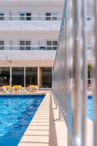 a swimming pool in front of a building at Port Fiesta Park in Benidorm