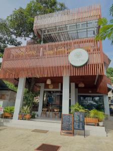 a restaurant with a sign in front of it at Puu Pau Hotel & Coffee Shop in Labuan Bajo