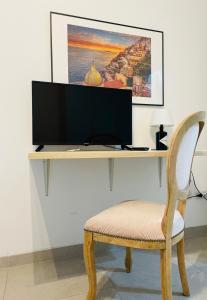 a desk with a computer monitor and a chair at Apartment Petrarca 13 R5331 in Pirri