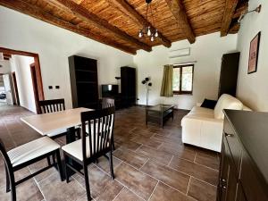 a living room with a table and a couch at Penny Apartmanok Szigetvár in Szigetvár