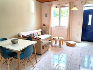 a living room with a couch and a table at Stone Family Home Garden Center Beach in Kyparissia