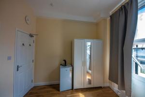 a room with a white cabinet and a door at Central quality point piccadilly in London
