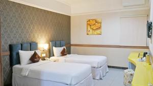 Postel nebo postele na pokoji v ubytování Amarelo Hotel Solo