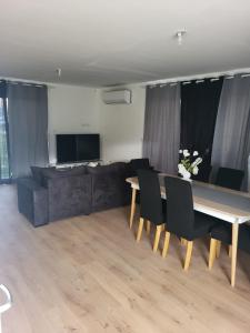 a living room with a table and a couch at MAISON C in Saint-Jean-de-Thurigneux +3 photos