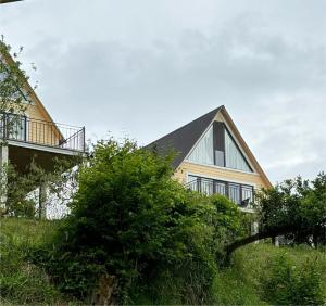 a house with a balcony on the side of it at Cozy Cottages Kondidi in Kobuleti