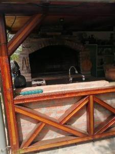 a kitchen with a sink and a stone fireplace at Katun in Vrdnik +17 photos