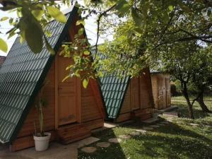 a row of wooden huts in a yard at Katun in Vrdnik