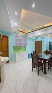 a kitchen with a table and chairs in a room at Baridhara Sweet Home in Dhaka