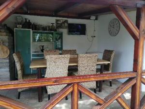 a dining room with a wooden table and chairs at Katun in Vrdnik