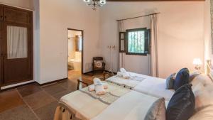 a large room with two beds and a window at El Encinar Antequera - La Joya by Ruralidays in Antequera +20 photos