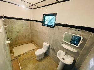 a bathroom with a toilet and a sink at Ella Jungle Cottage in Ella