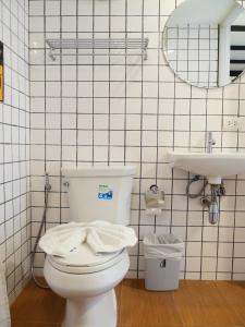 a bathroom with a toilet and a sink at Book a Bed Poshtel - SHA Plus in Phuket
