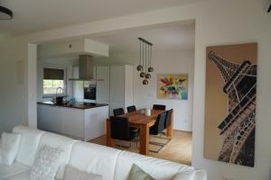 a living room and kitchen with a table and a couch at Casa Capodistria with sea view in Koper