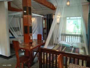 a dining room with a table and a window at Lovers Green Villa in Matara