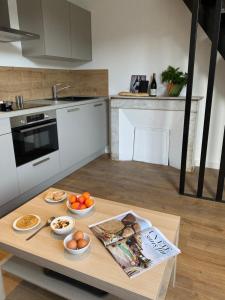 a kitchen with a table with bowls of food on it at Plein Centre Bastia in Bastia +1 photo