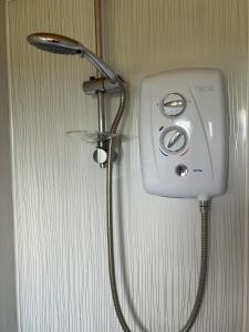 a shower head is attached to a wall at Wee Shepherds Hut Maybole in Maybole